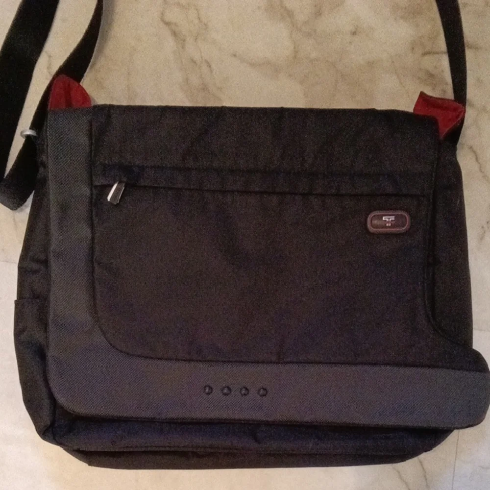 Tumi Black Laptop Messenger Bag.
